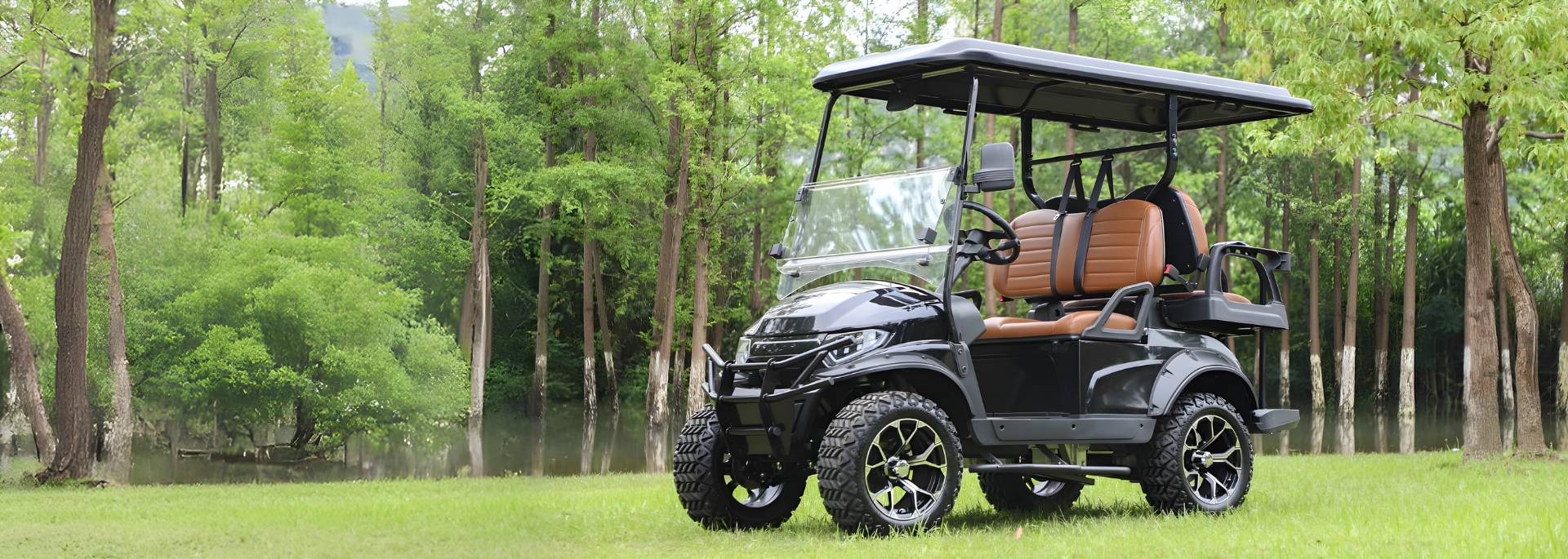 Golf cart on a grassy area with trees in the background