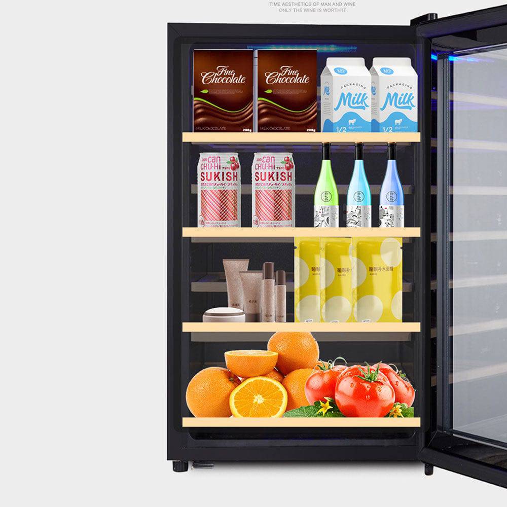 Small refrigerator with various items including drinks, fruits, and vegetables on a white background