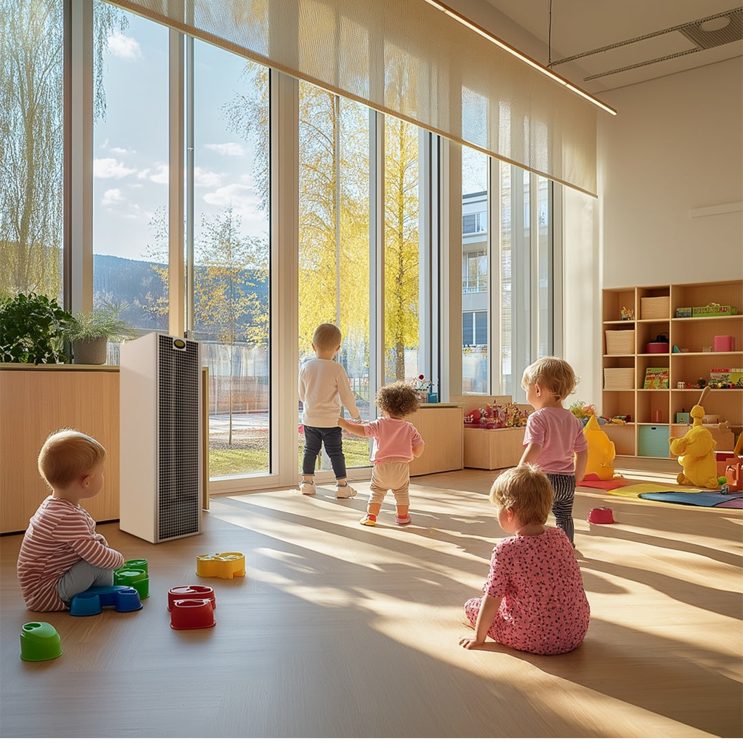Children playing in a modern classroom with large windows and educational toys.