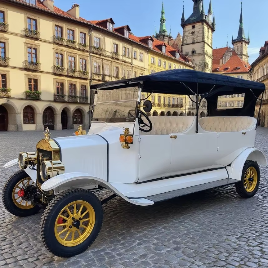 Vintage white car with gold details on a cobblestone street in front of historic buildings.