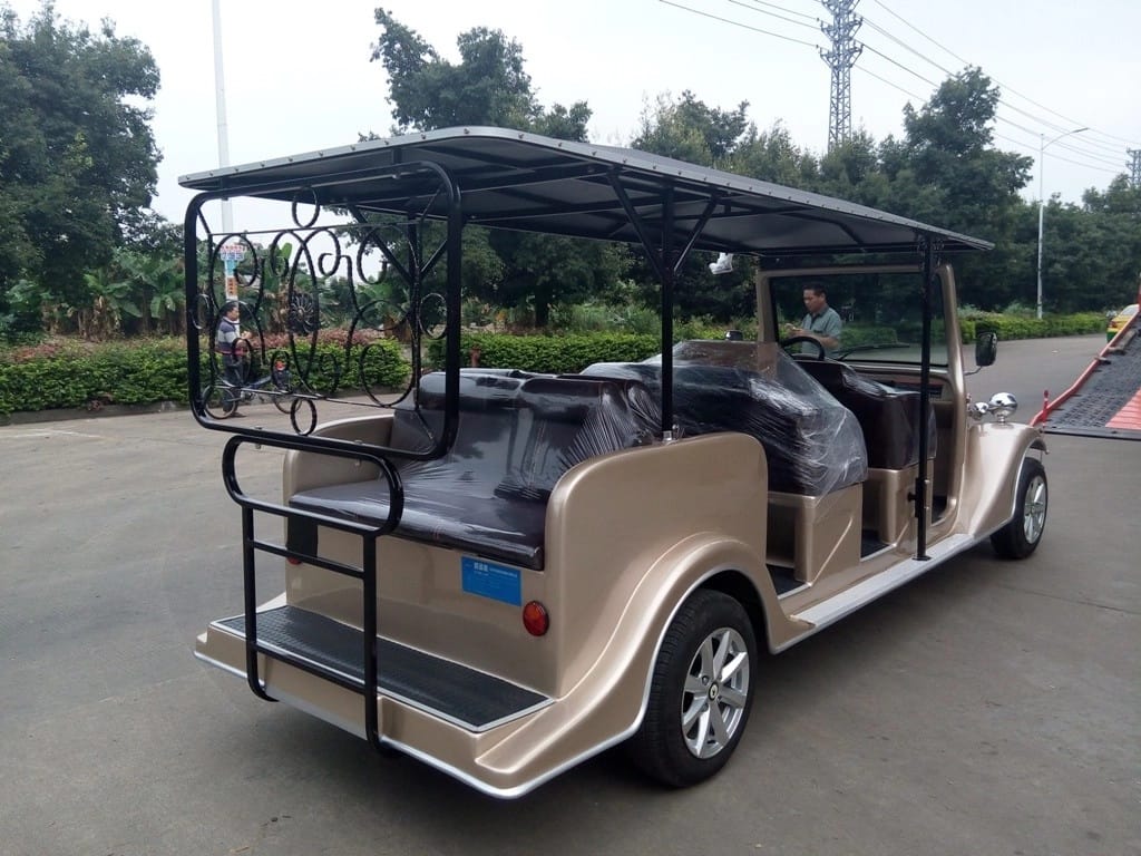 Beige electric vehicle with a canopy on a road