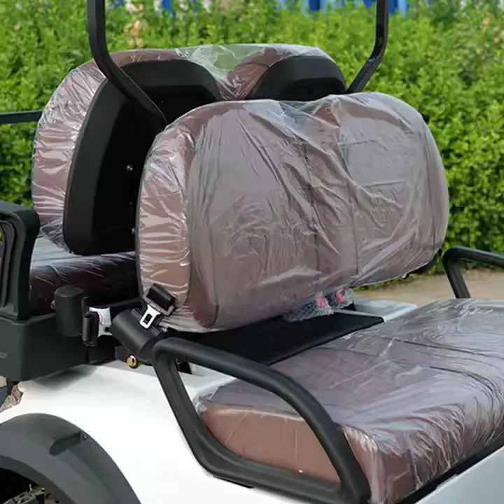 Motorcycle seat with plastic cover on a green outdoor background