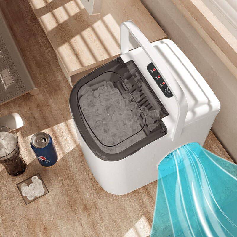 Portable ice maker on a wooden floor with a can of Pepsi and a glass of ice nearby.