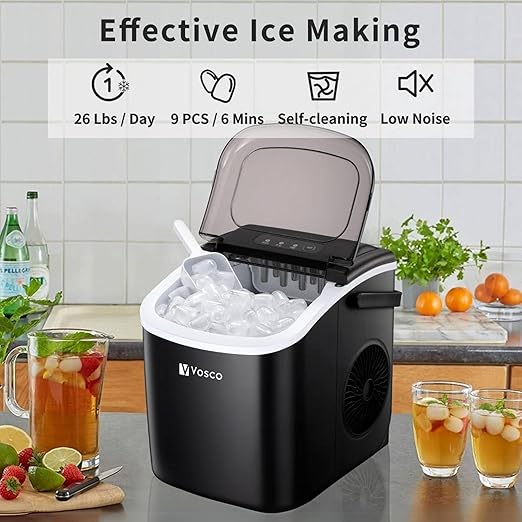 Black ice maker with ice cubes on a kitchen counter, surrounded by drinks and fruits.