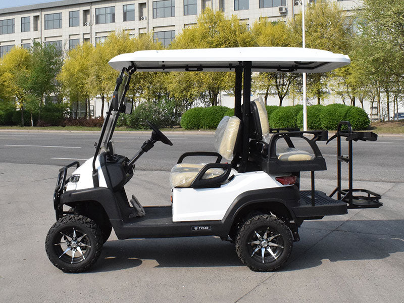 White golf cart with a canopy on a paved area with trees and buildings in the background
