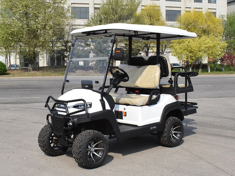 White golf cart with black accents on a paved road with trees and buildings in the background