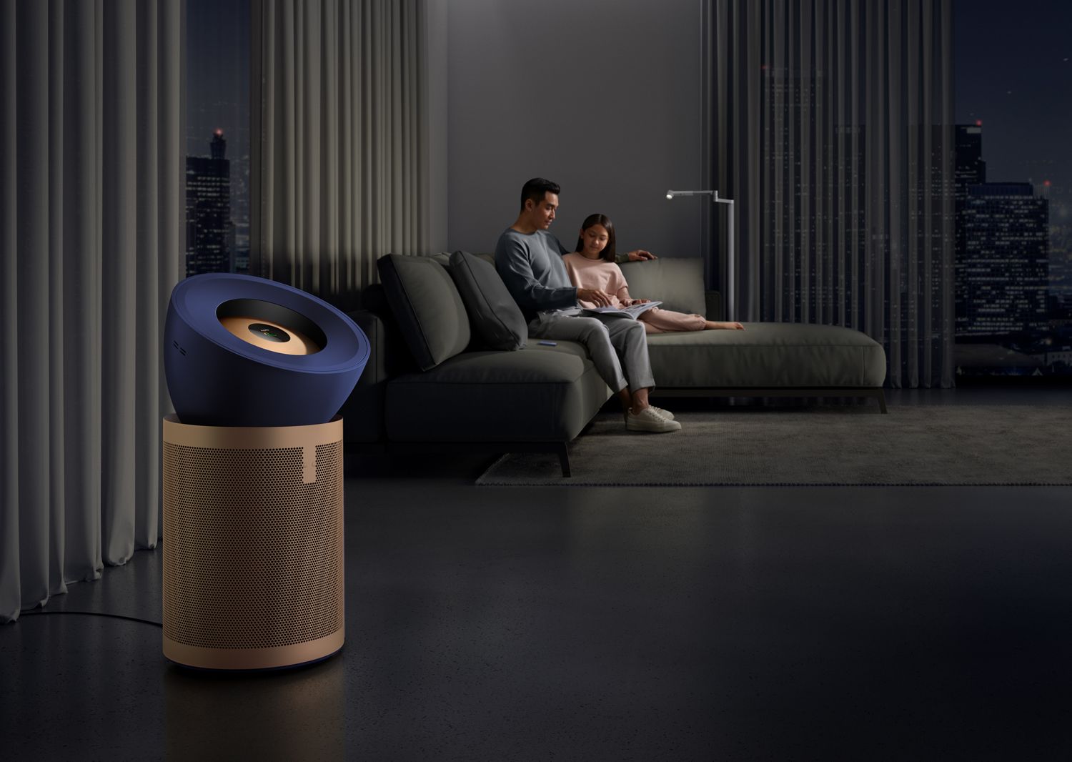 Modern living room with a couple sitting on a sofa and an air purifier in the foreground.