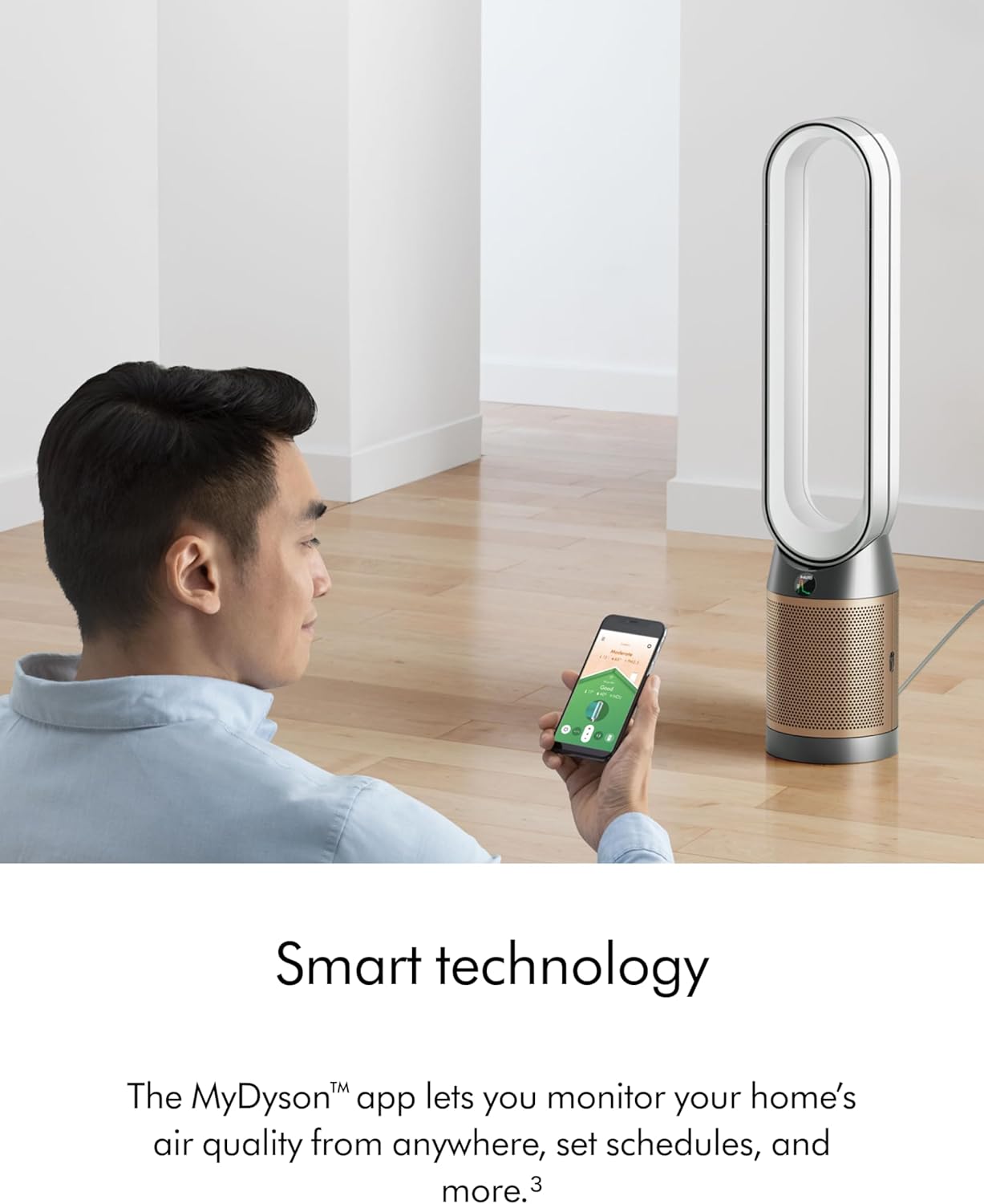 Person using a smartphone app to control a Dyson air purifier in a room.